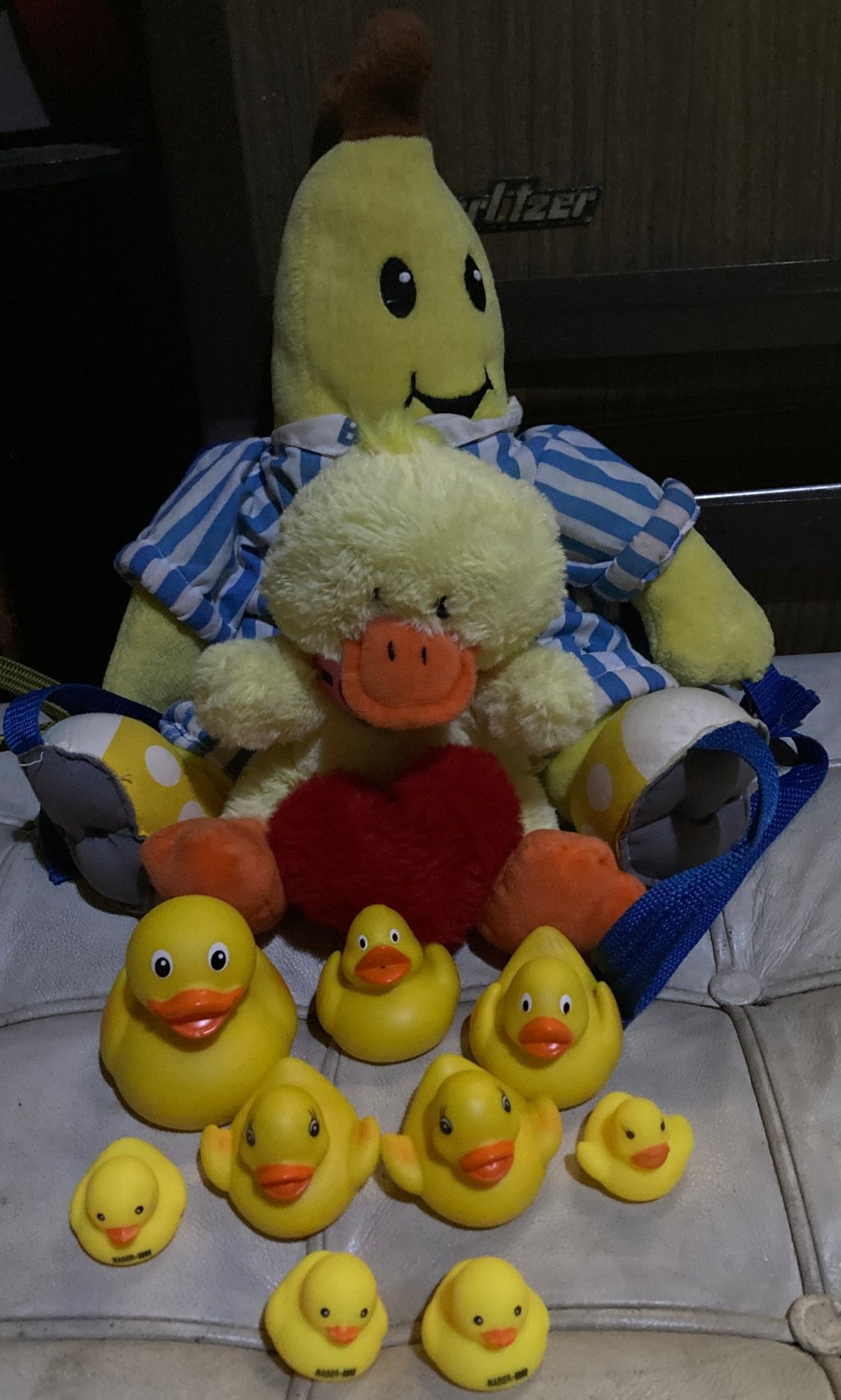 Banana backpack wearing striped pyjamas. 8 rubber duckies. Duck plushy holding loveheart.