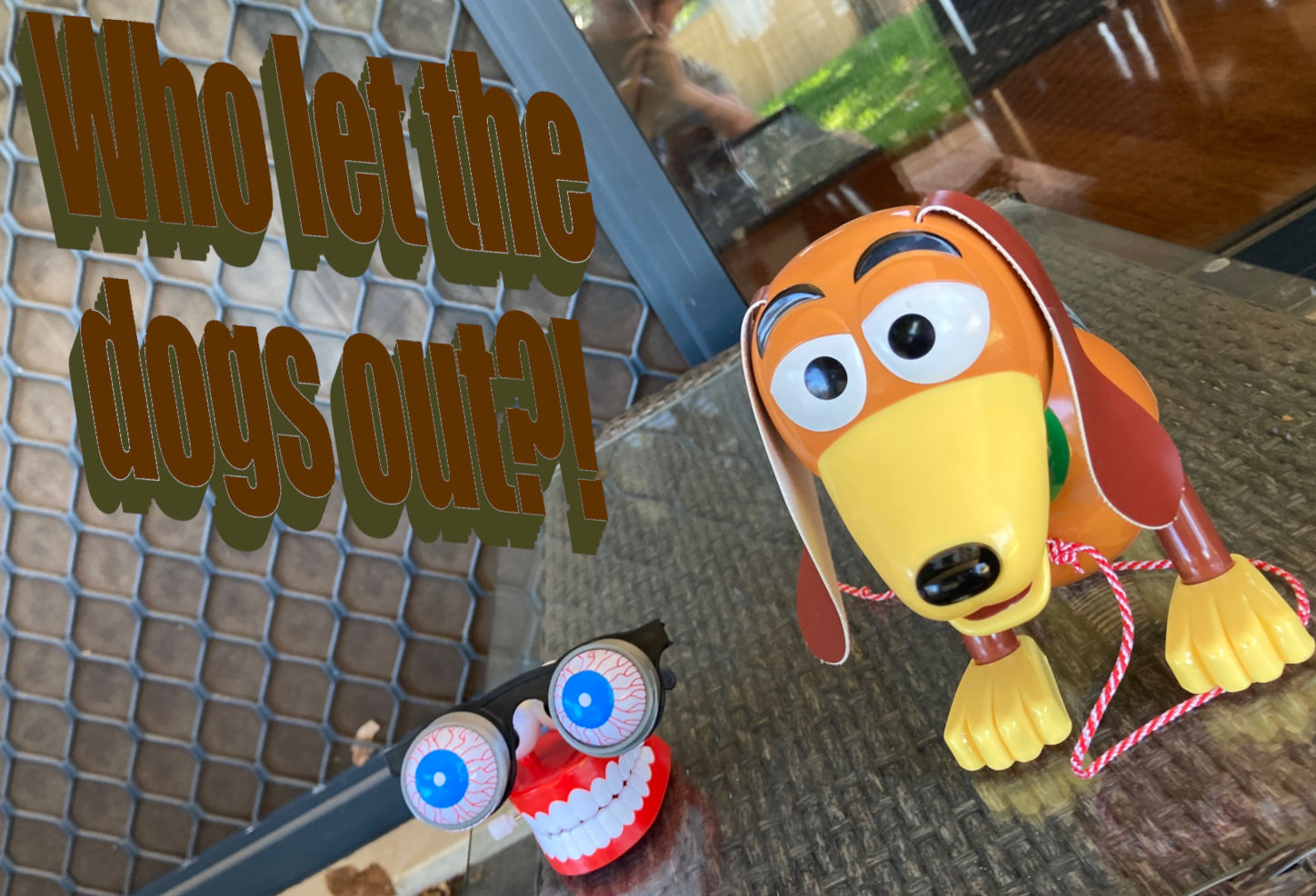 Slinky Dog next to chattering teeth. Text reads 'Who let the dogs out?!' 