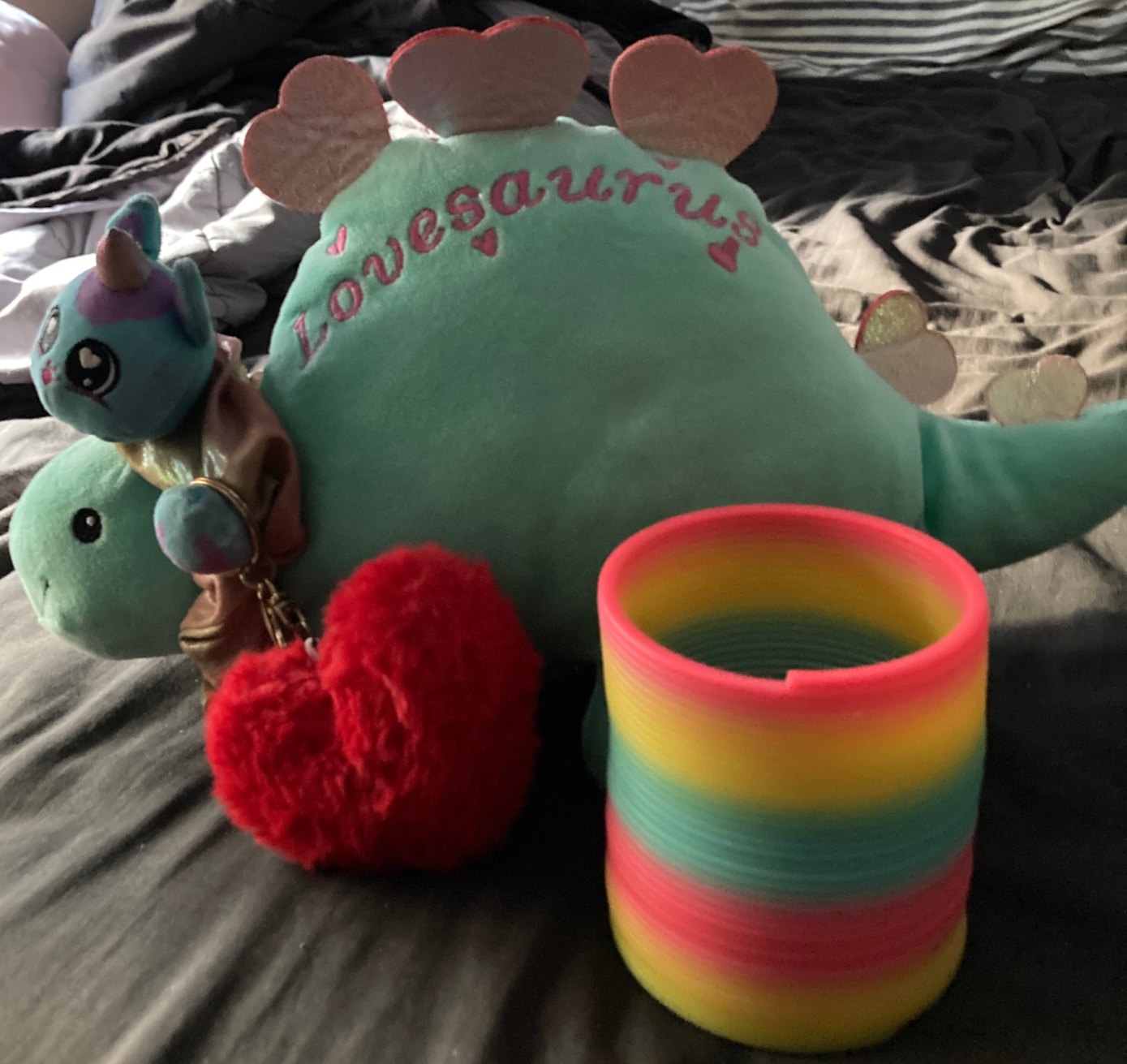 Small blue dinosaur, heart shaped body, scrunchy around neck. With Slinky and loveheart keyring.
