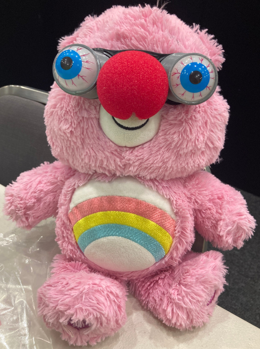 Care Bear plushy, googly glasses, red clown nose.